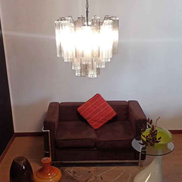 Murano Star Tube Chandelier with clear glass above a dark brown sofa with a red cushion