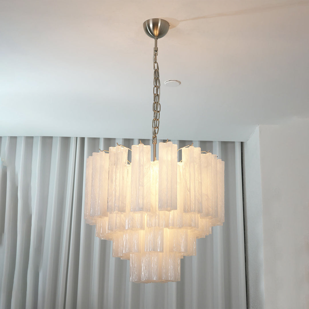 Murano Star Tube Chandelier with clear glass hanging in a bright room with sheer white curtains