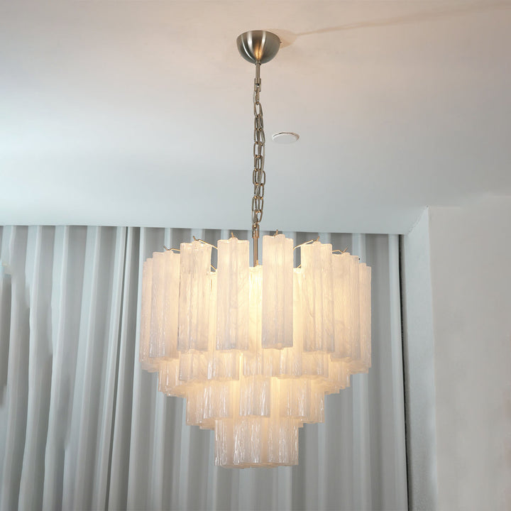 Murano Star Tube Chandelier with clear glass hanging in a bright room with sheer white curtains