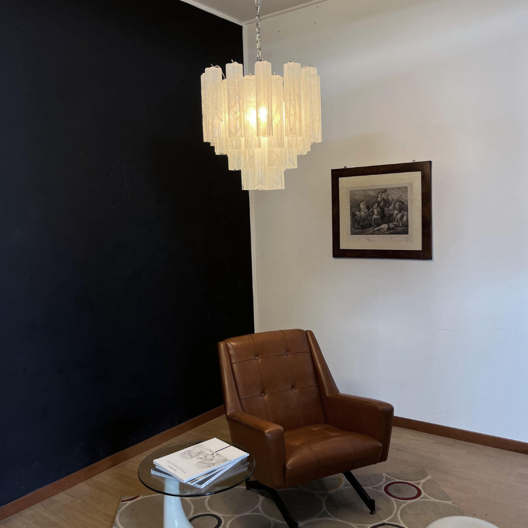 Murano Star Tube Chandelier with clear glass hanging in a bright room with sheer white curtains