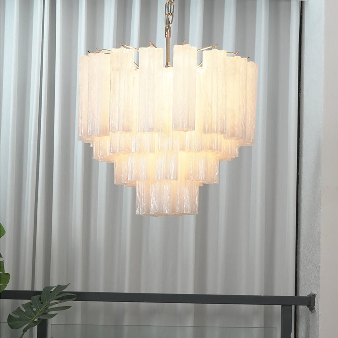 Murano Star Tube Chandelier with clear glass hanging on a plain white wall with sheer curtains