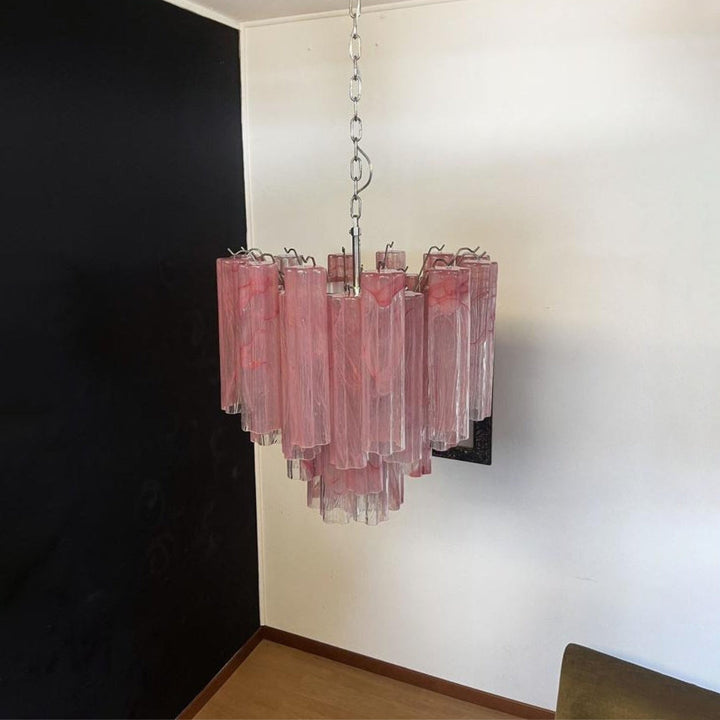 Murano Star Tube Chandelier with pink glass hanging in a dark corner with black and white walls
