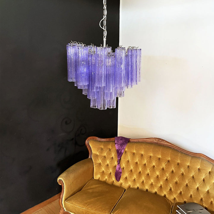 Murano Star Tube Chandelier with purple glass above a vintage gold tufted sofa with decor