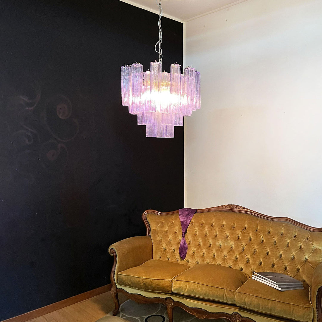 Murano Star Tube Chandelier with purple glass above a vintage gold tufted sofa with decor