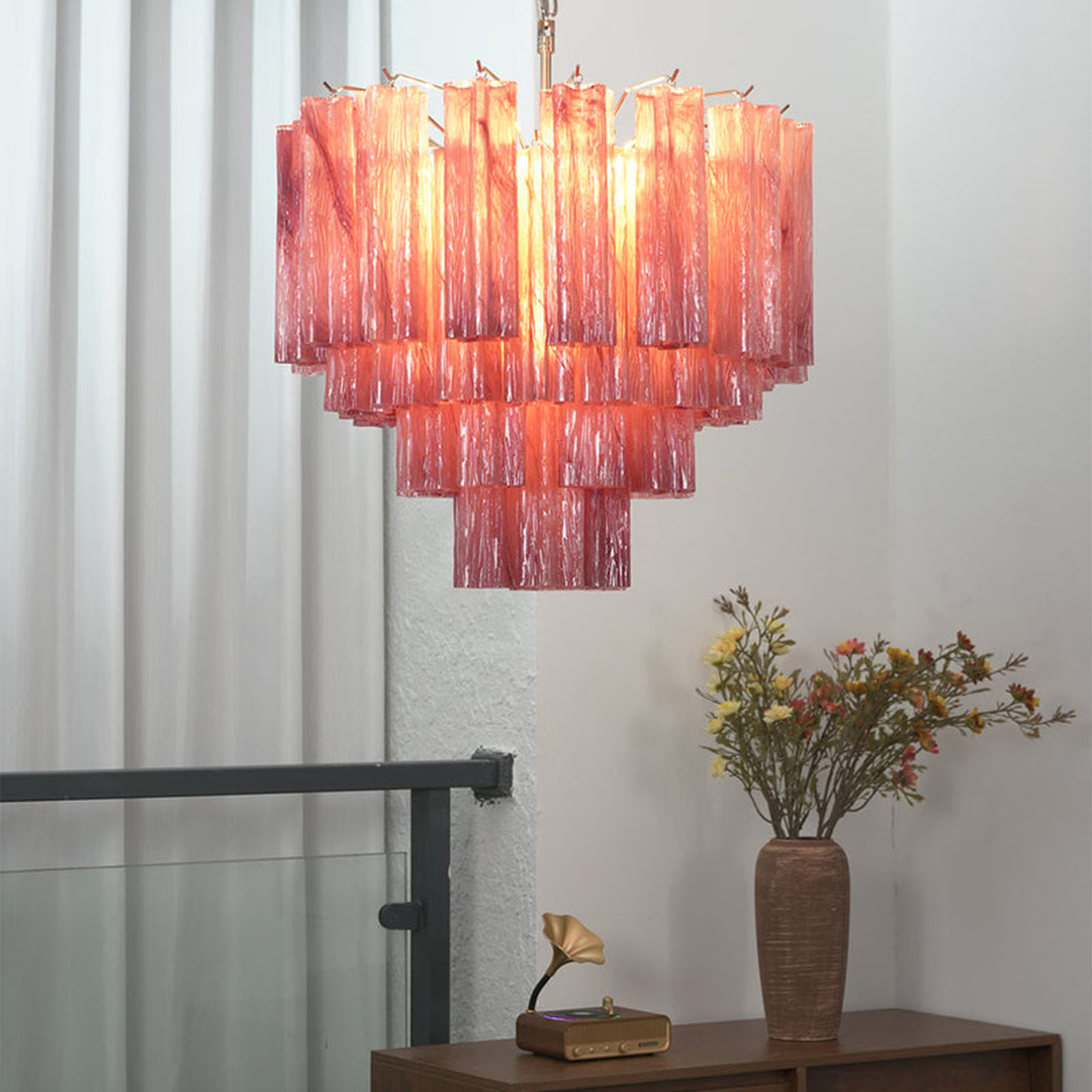 Murano Star Tube Chandelier with red-pink gradient glass hanging in a bright room with sheer curtains