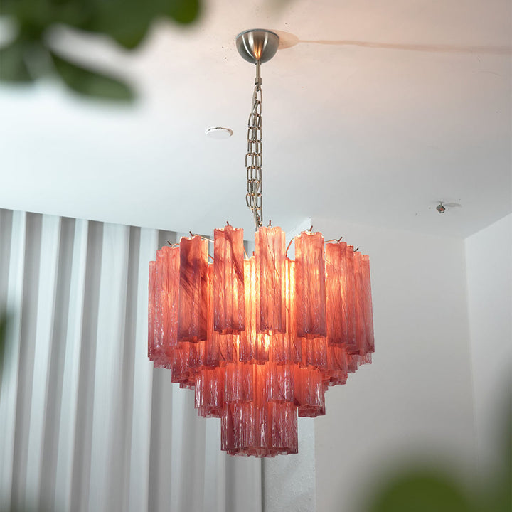 Murano Star Tube Chandelier with smoke gray glass against a black accent wall with a brown sofa