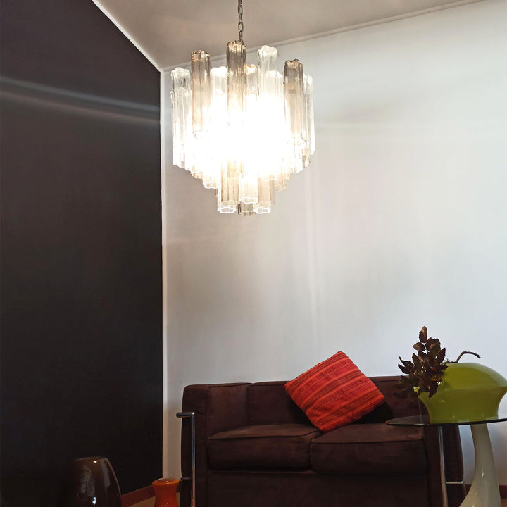 Murano Star Tube Chandelier with smoke gray glass above a dark brown sofa with decor accents
