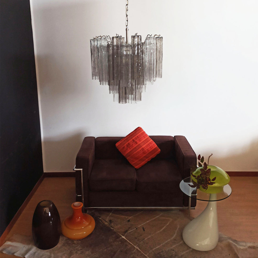Murano Star Tube Chandelier with smoke gray glass above a dark brown sofa with a red cushion