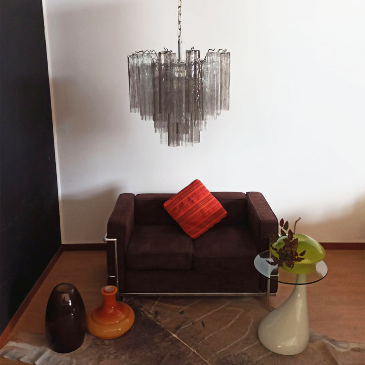 Murano Star Tube Chandelier with smoke gray glass above a dark brown sofa with a red cushion