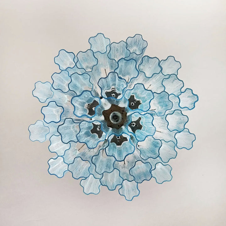 Top view of Murano Star Tube Chandelier with turquoise star-shaped glass elements on white background