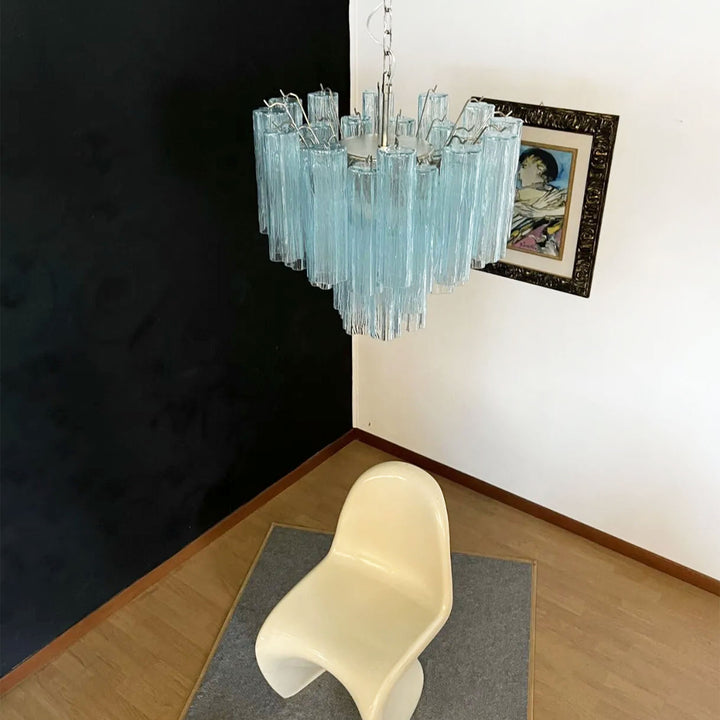 Murano Star Tube Chandelier with turquoise glass in a room with a white modern chair