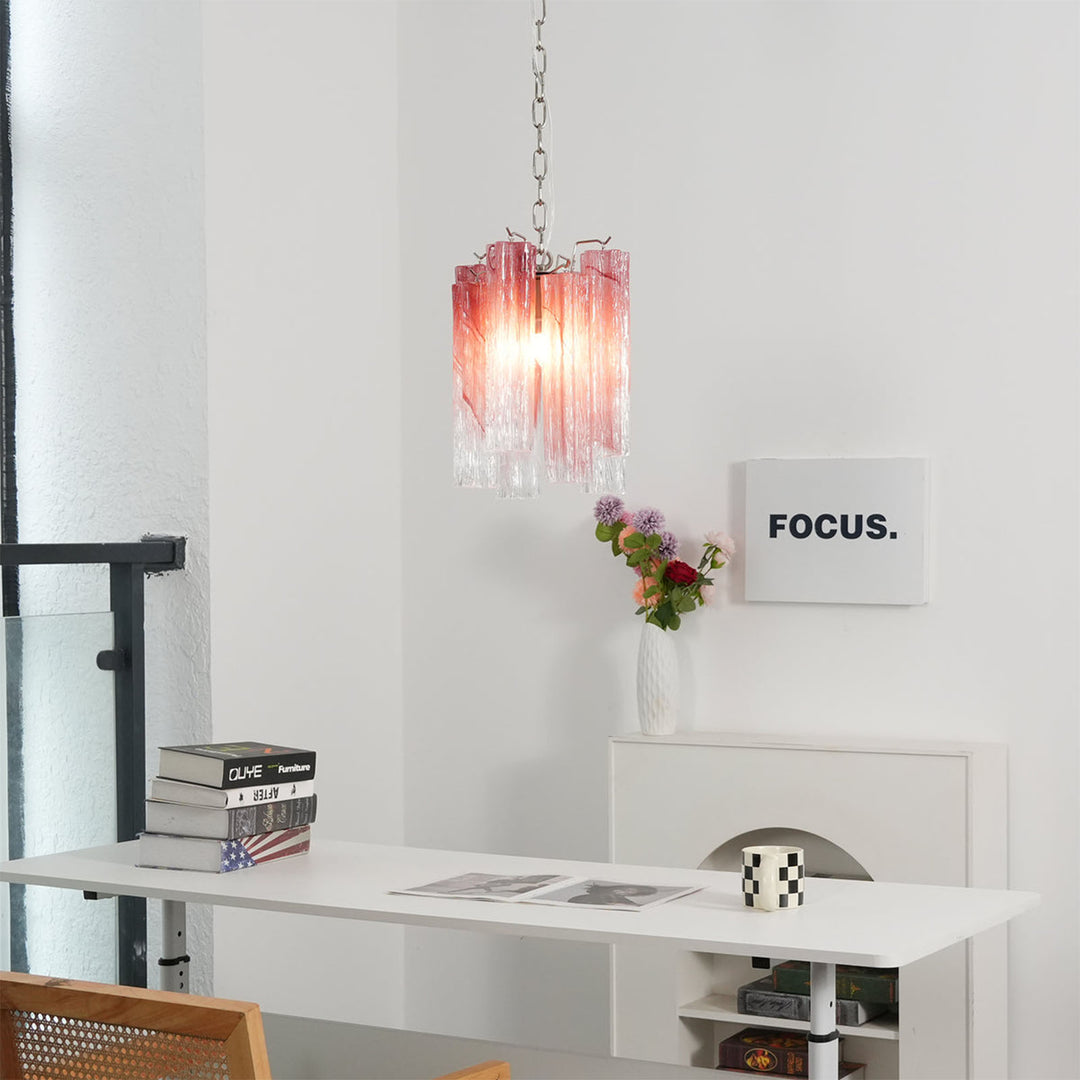 Murano Tubes Glass Chandelier with pink gradient glass hanging above a desk with books and plants