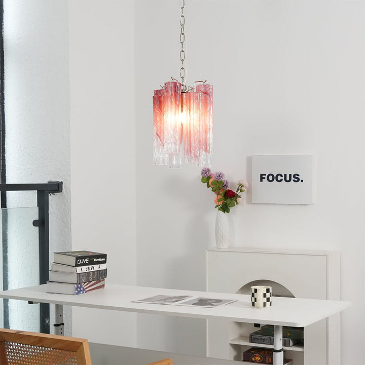 Murano Tubes Glass Chandelier with pink gradient glass hanging above a desk with books and plants