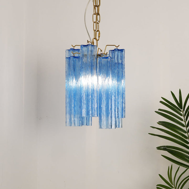 Murano Tubes Glass Chandelier with bright blue glass hanging in a minimalist room with plants
