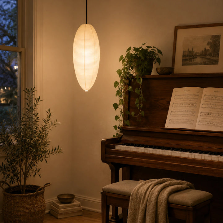 Oval paper pendant lighting a cozy music room beside an upright piano