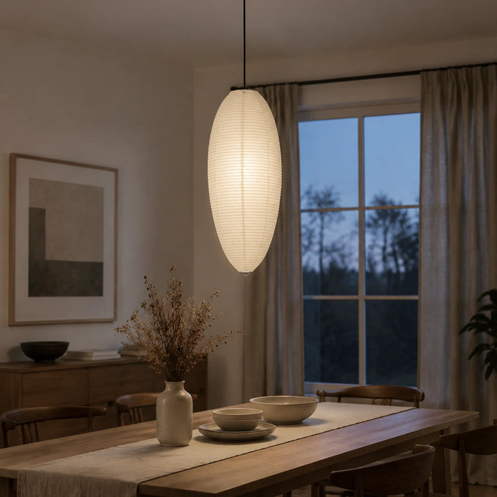 Oval paper pendant in an open-plan kitchen and dining space at dusk