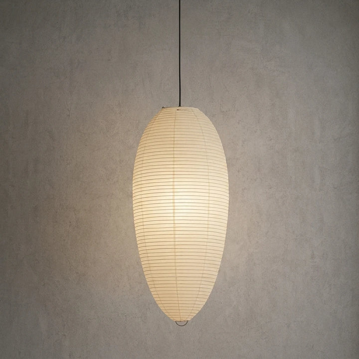 Oval paper pendant hung against a plain textured grey wall