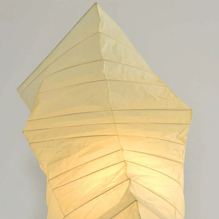 Close-up of the paper shade panels glowing warm amber when lit