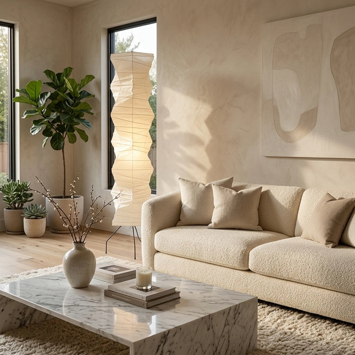 Paper lantern floor lamp beside a linen sofa in a neutral living room