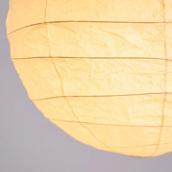 Close-up of the seam and rib construction across the paper shade surface
