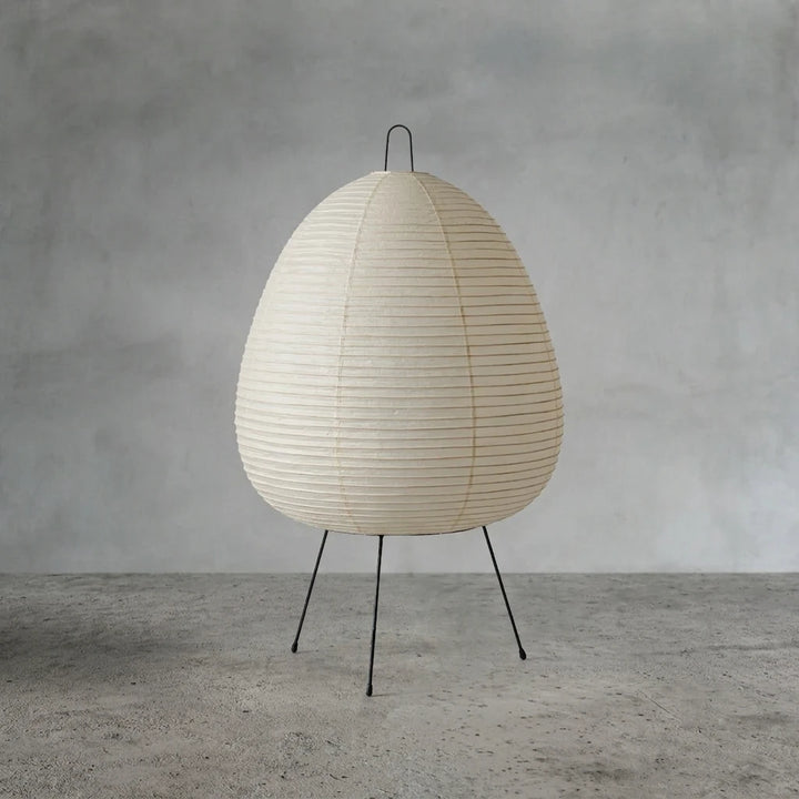 Egg-shaped paper table lamp unlit, showing its soft off-white shade in daylight