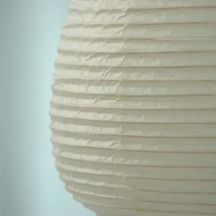 Close-up of the finely ribbed mulberry paper shade showing its natural fiber texture