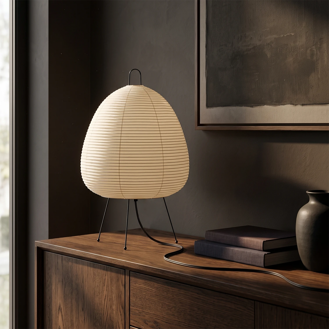 Rice paper table lamp on a dark wood sideboard against a charcoal wall