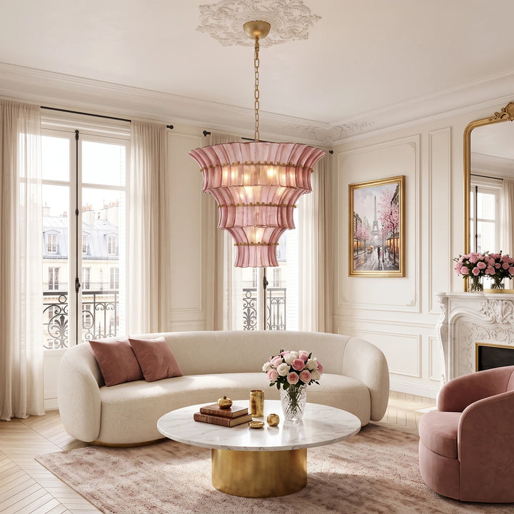 Rose glass chandelier above a curved sofa in a soft blush sitting room