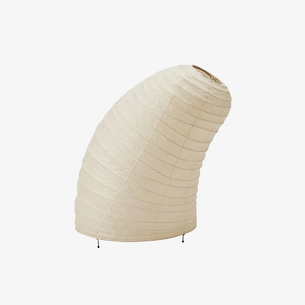 Sculptural curved mulberry paper table lamp with a shell-shaped shade on a soft grey background