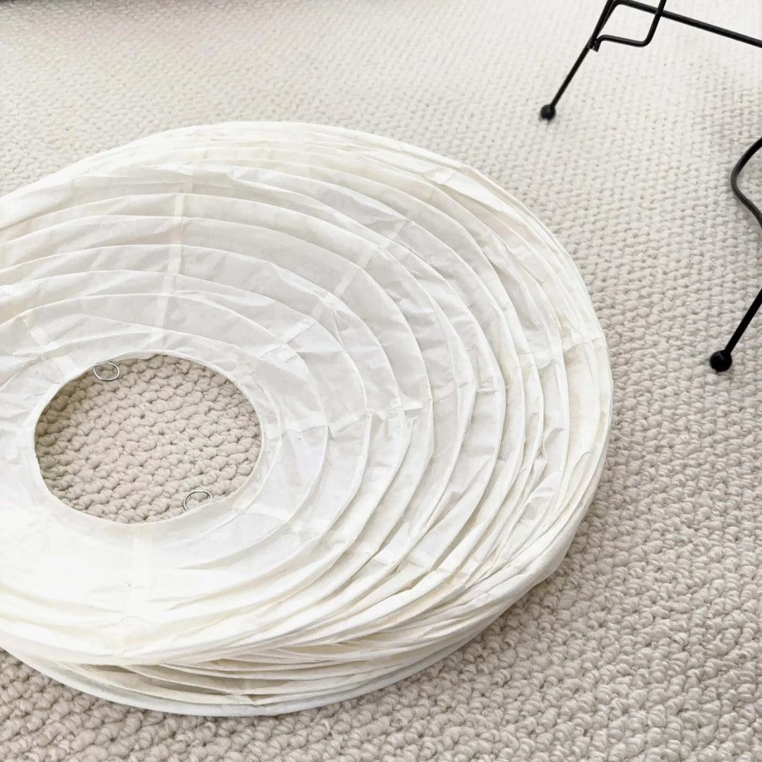 Detail of the sculptural paper lamp glowing warm from within