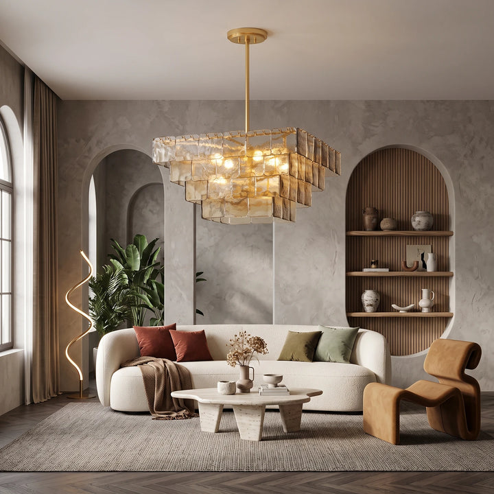 Smoked glass chandelier above a curved sofa in a room with arched niches