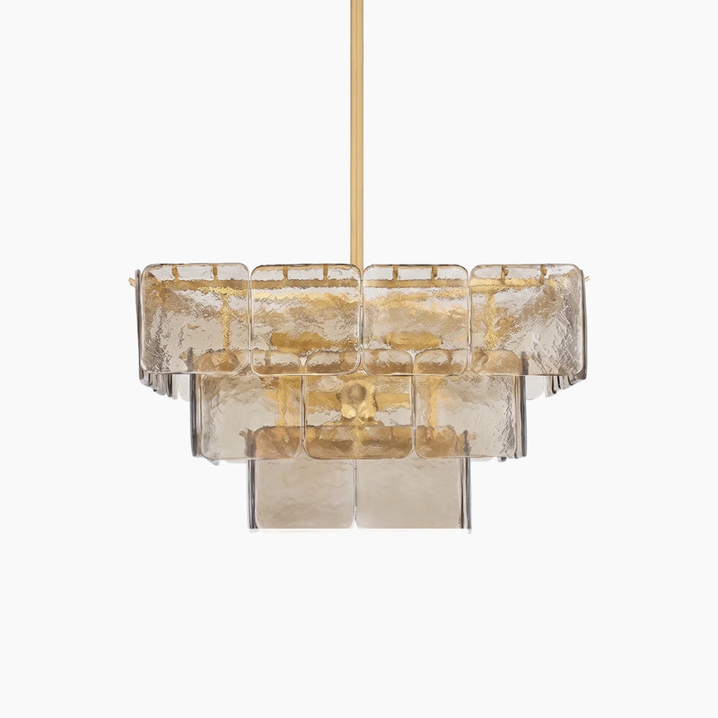 Tiered smoked glass panel chandelier with a brass frame on a light gray background
