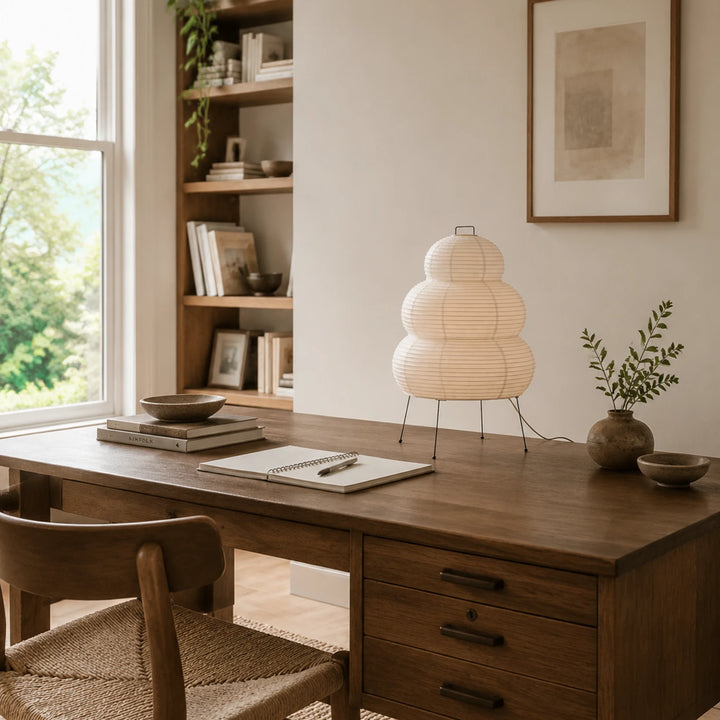 Stacked paper table lamp on a table in a dining corner with an armchair