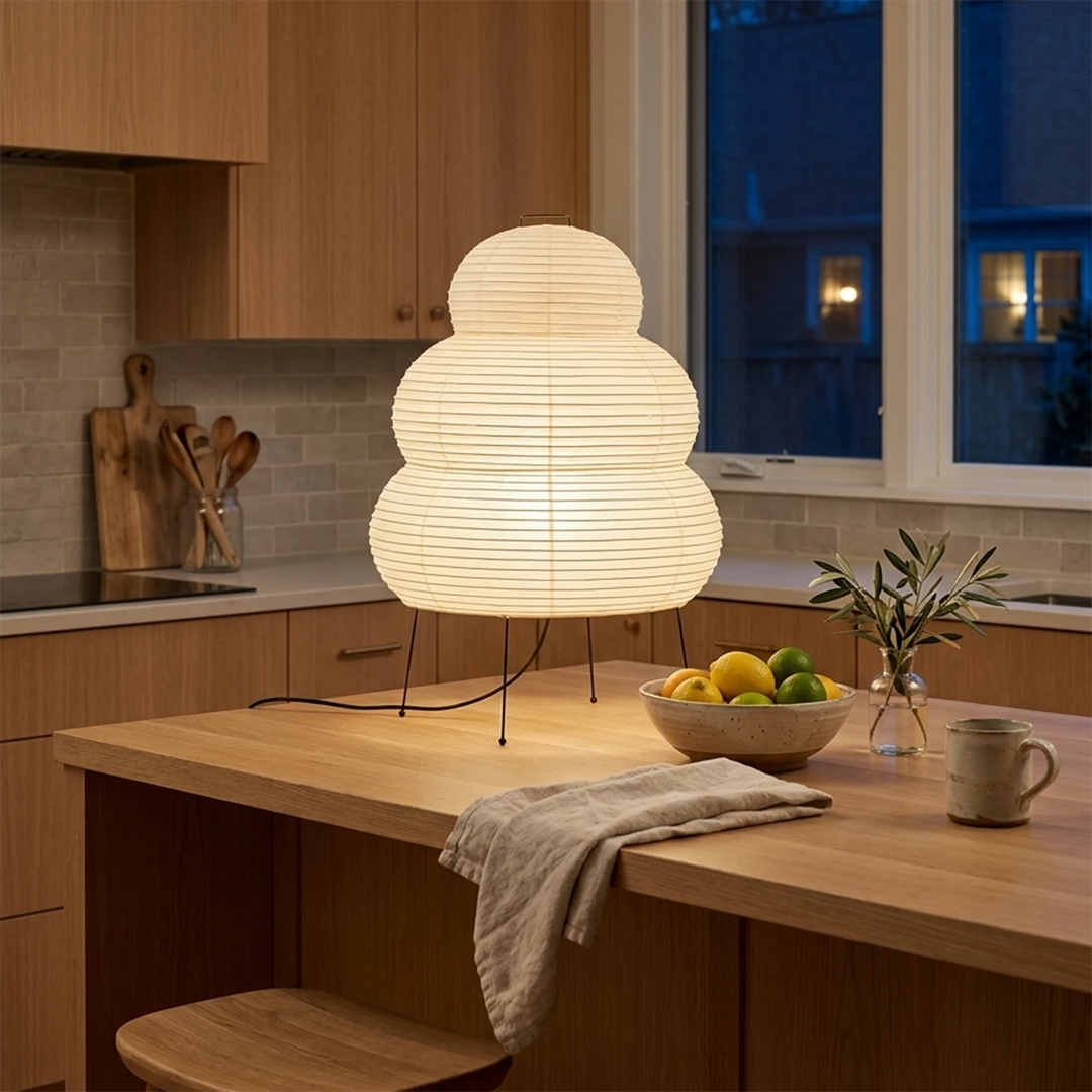Stacked paper table lamp on a kitchen counter by a bright window