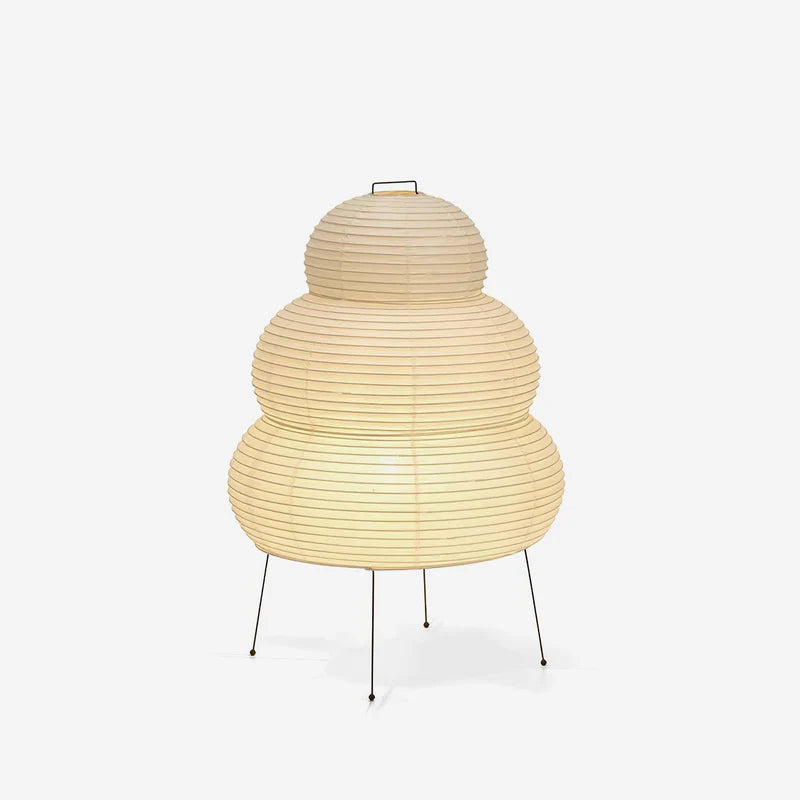 Stacked paper lantern table lamp shown lit against a pale grey studio backdrop