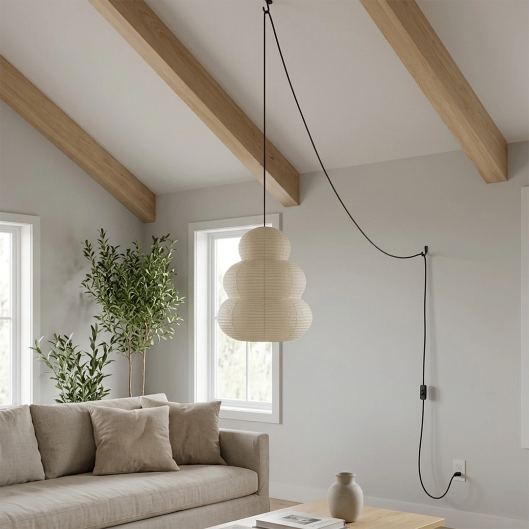 Stacked paper pendant hung from beams in a bright lounge corner