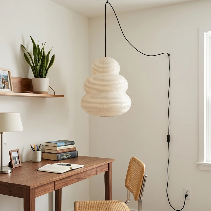 Stacked paper pendant above a study desk in soft daylight