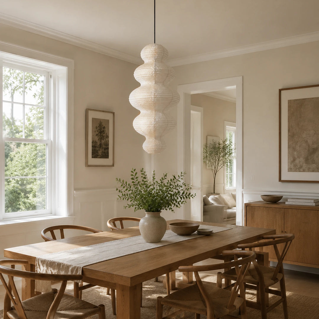 Stacked paper pendant above a dining table in a bright airy room