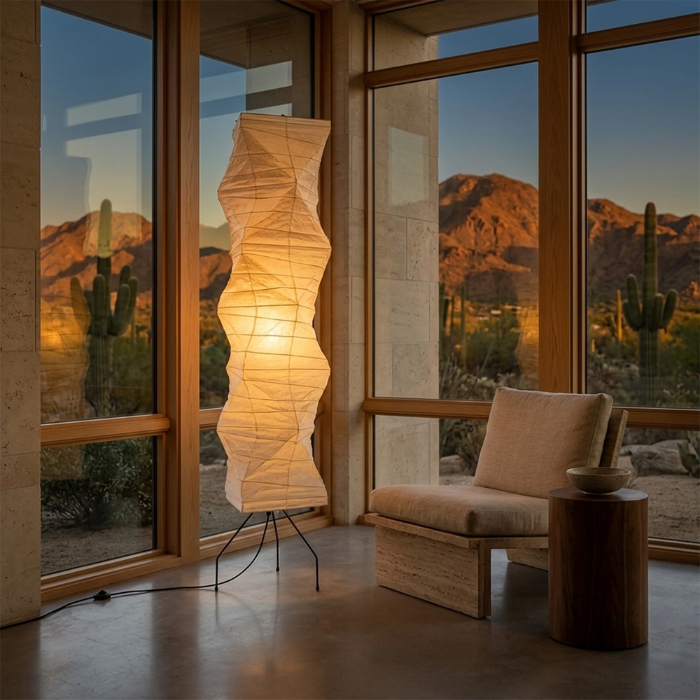 Statement paper floor lamp beside floor-to-ceiling windows with a desert landscape view