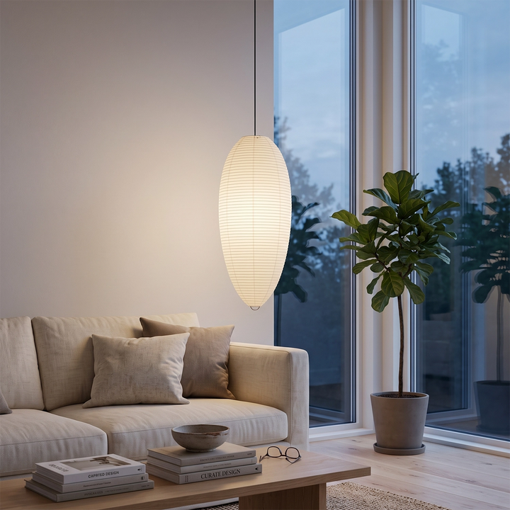 Oval paper pendant glowing in a bright studio corner with open shelving