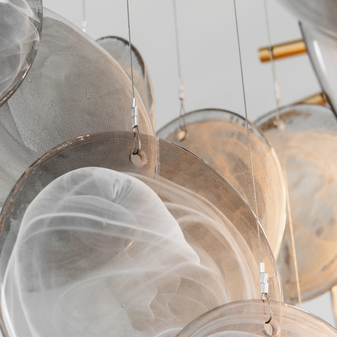 Close up of overlapping glass discs showing the swirled pattern inside each piece
