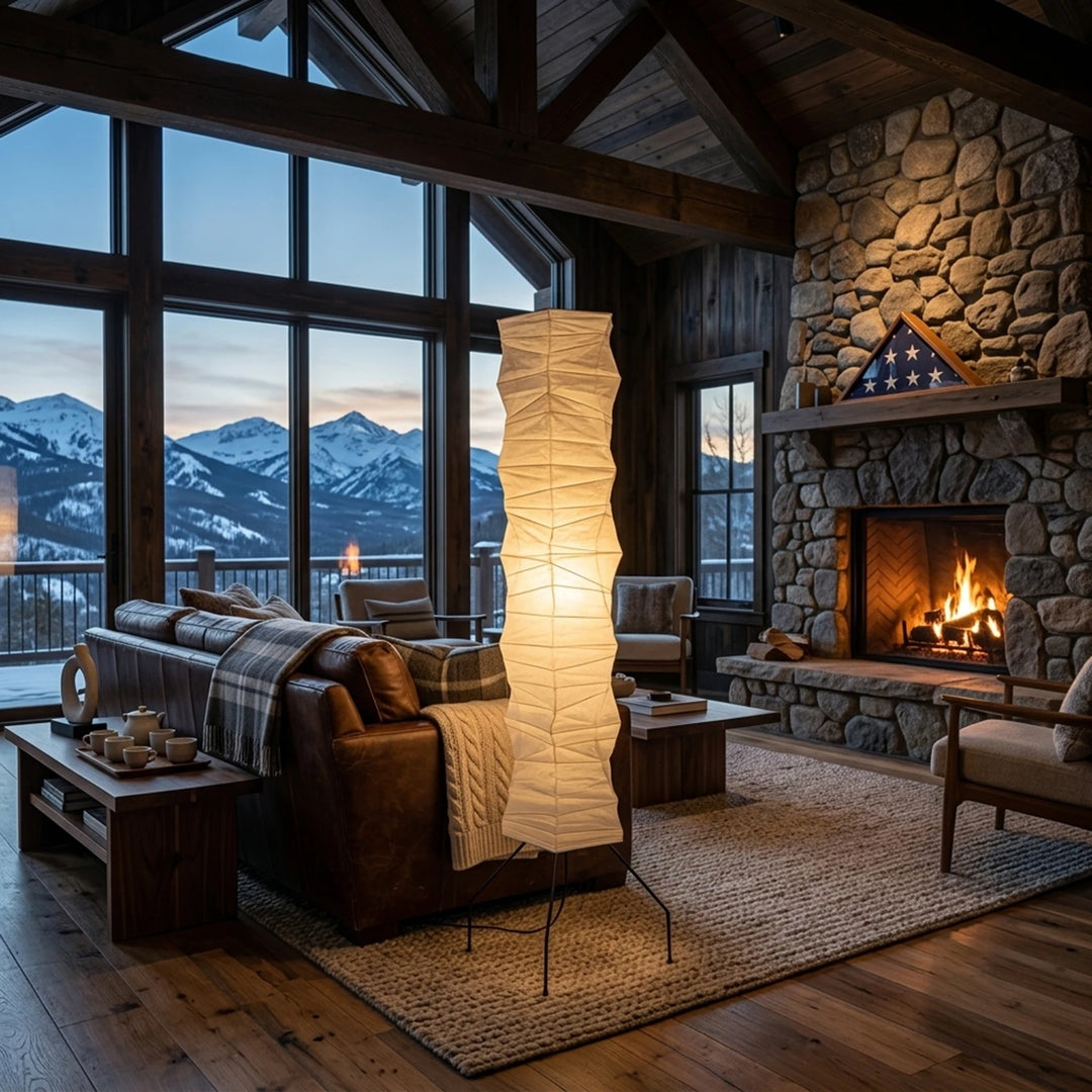 Tall column paper floor lamp in an alpine lounge with a stone fireplace