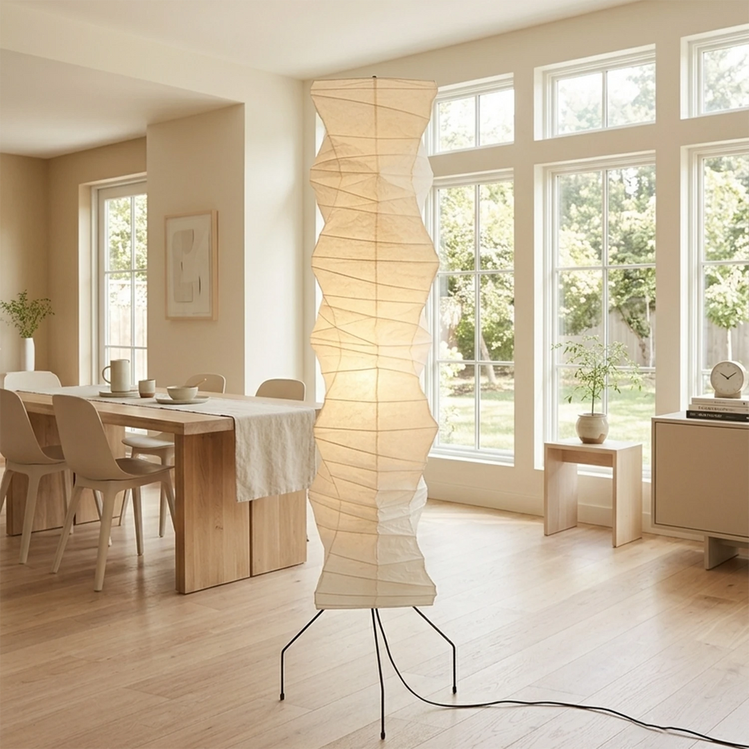 Tall paper floor lamp beside French windows in a sunlit dining room