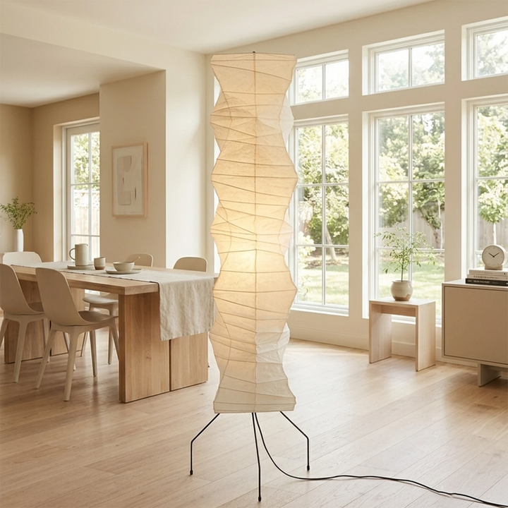 Tall paper floor lamp beside French windows in a sunlit dining room