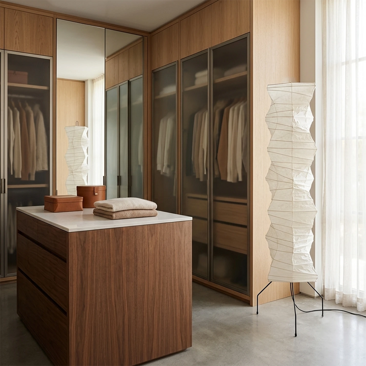 Paper floor lamp lighting a walnut walk-in wardrobe with mirrored doors