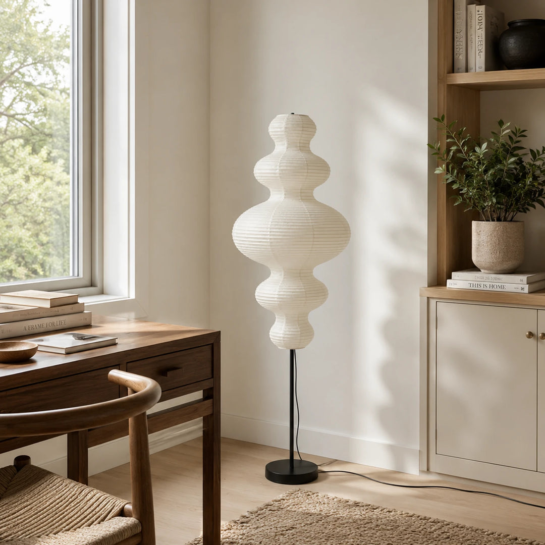 Tiered gourd paper floor lamp beside a wooden desk in a study corner