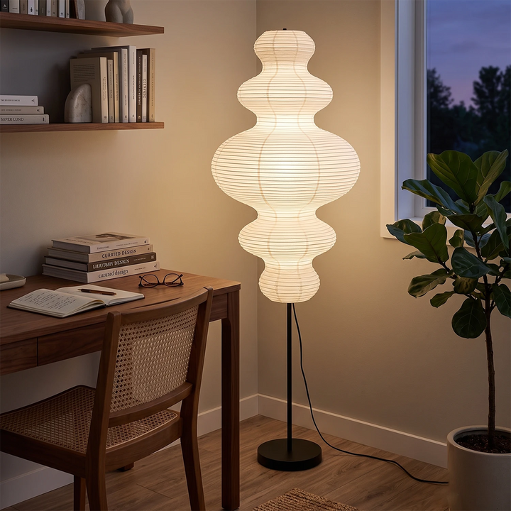 Tiered gourd paper floor lamp beside a desk in an evening home office