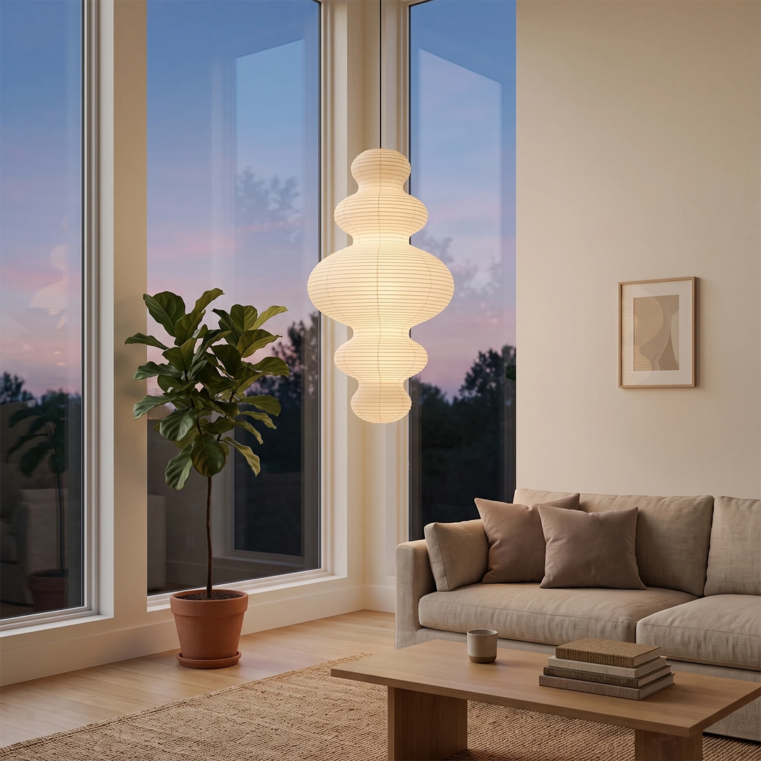 Tiered gourd paper pendant in a lounge beside floor-to-ceiling windows