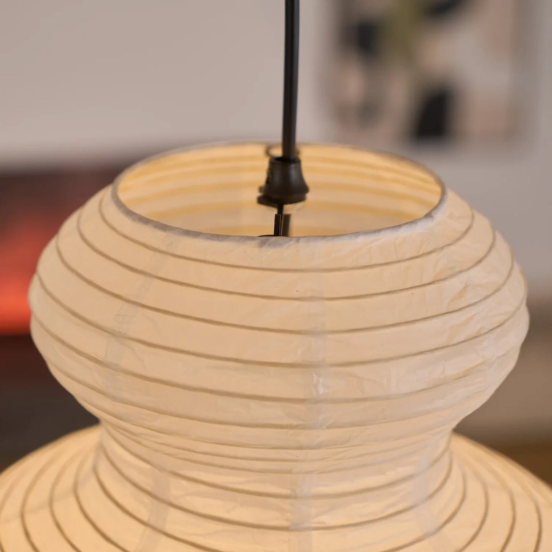 Close view of the tiered gourd paper pendant glowing warm from within