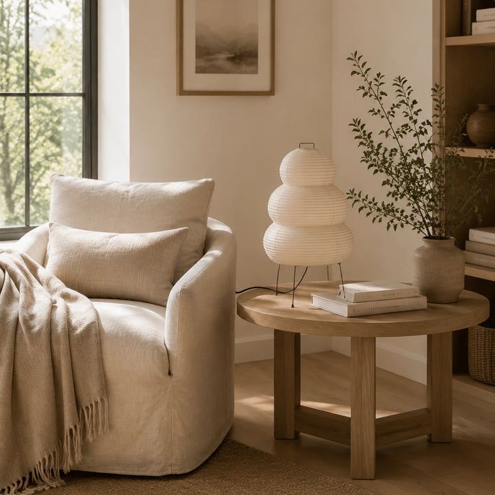 Tiered paper table lamp on a side table in a calm neutral living room